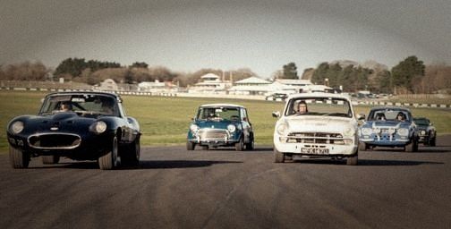 Classic saloons and sports cars racing side by side